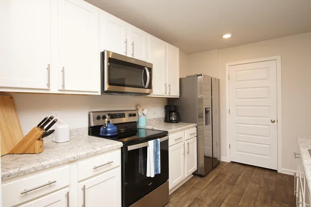 a kitchen with a table and chairs in it