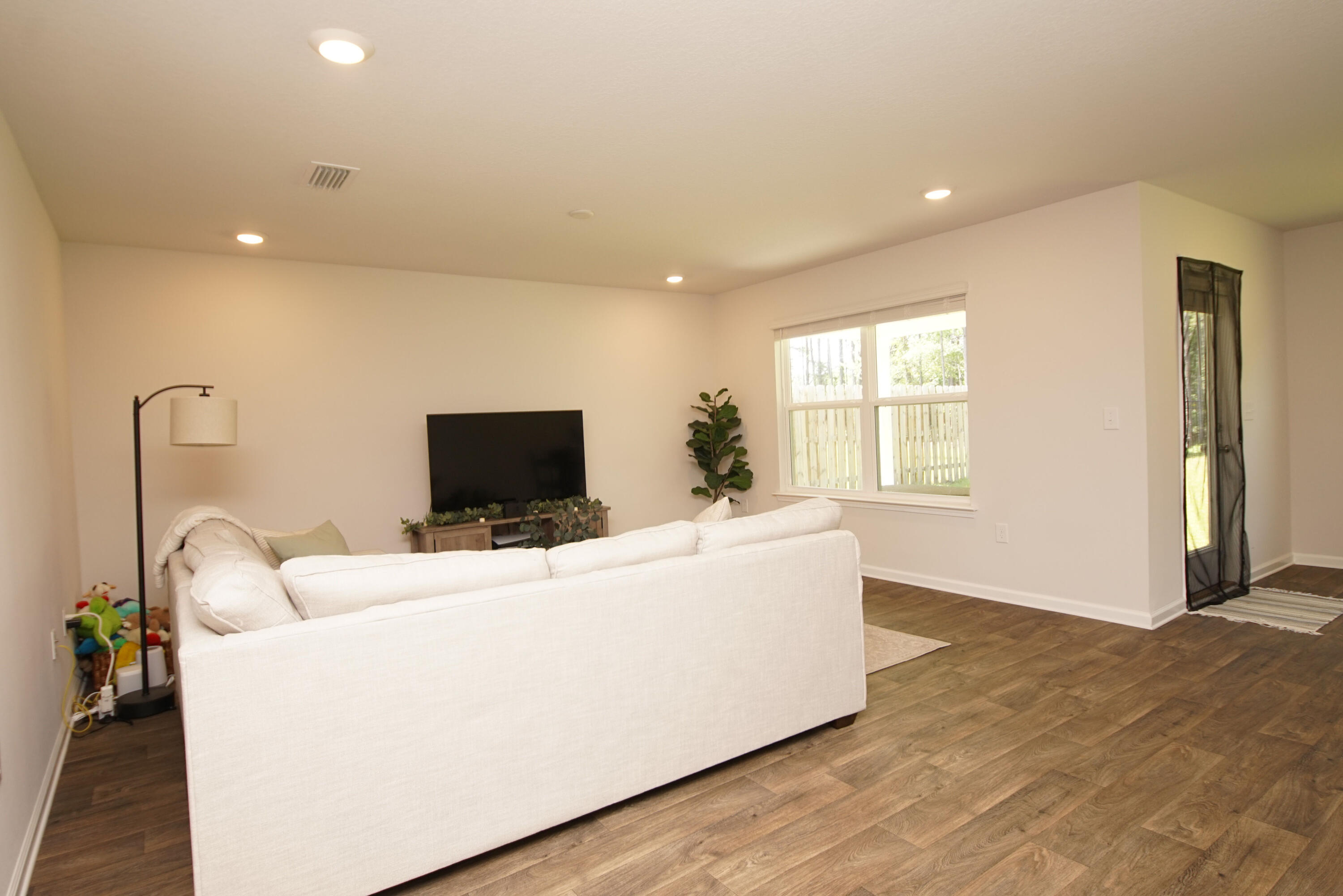 334 This Way Freeport, FL 32439 - Photo 25 of 55 a living room with furniture and a flat screen tv