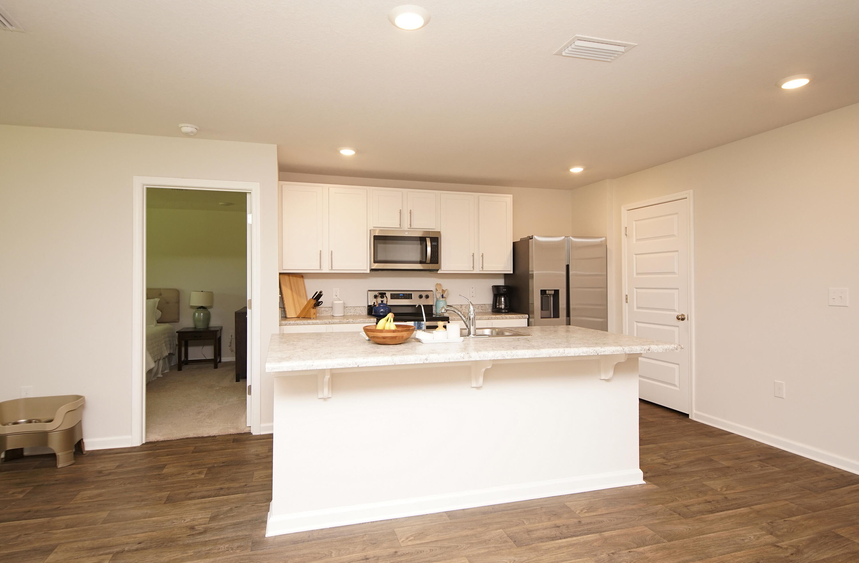 334 This Way Freeport, FL 32439 - Photo 9 of 55 a view of a kitchen with kitchen island a sink wooden floor and counter top space