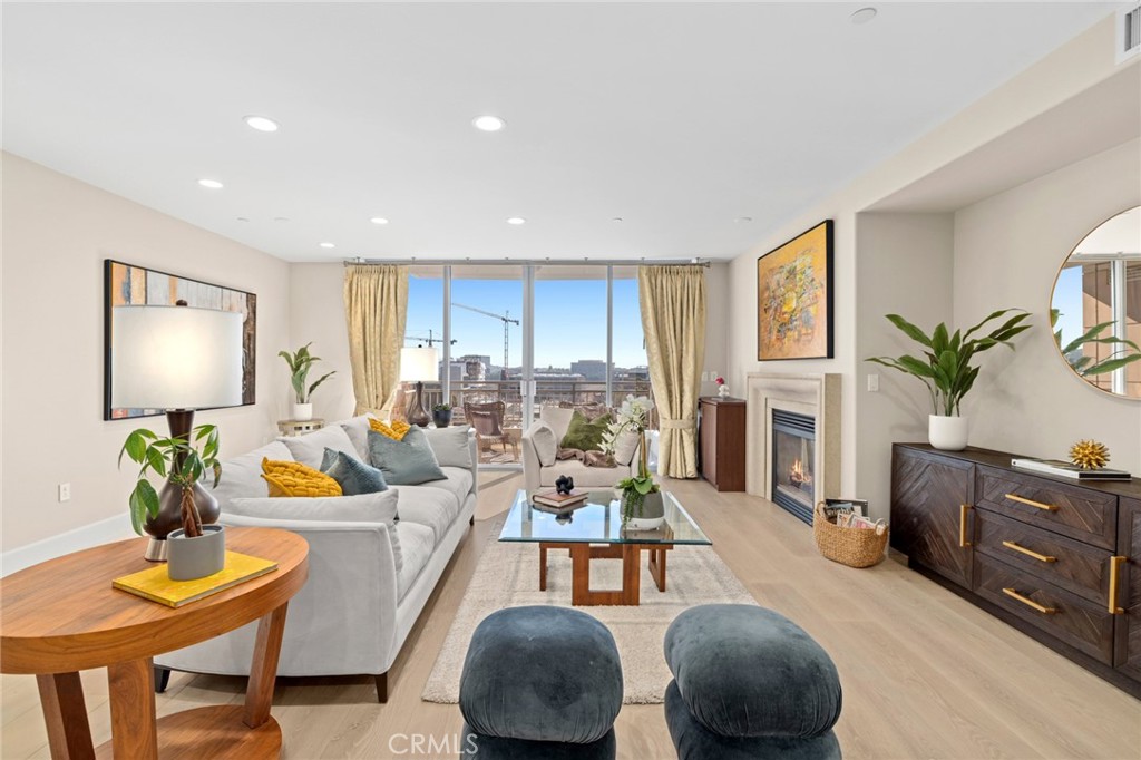 a living room with fireplace furniture and a potted plant