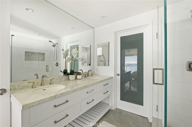 a bathroom with a double vanity sink and a mirror