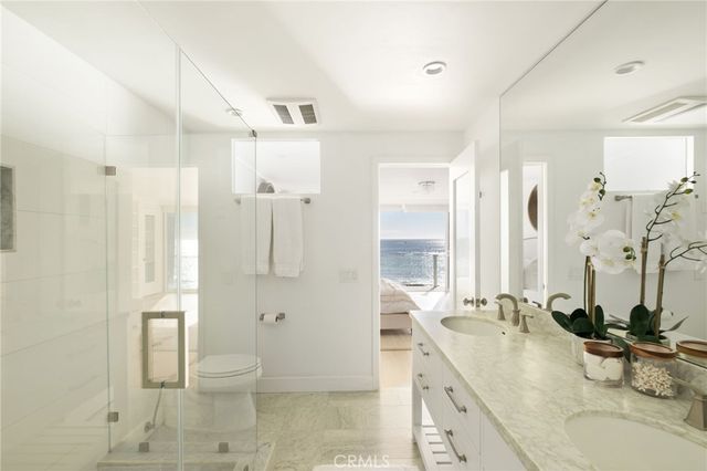 a bathroom with a double vanity sink toilet and shower