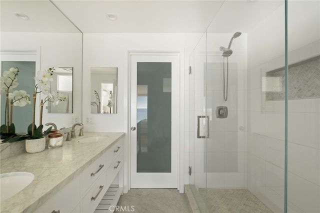 a bathroom with a granite countertop sink mirror and shower