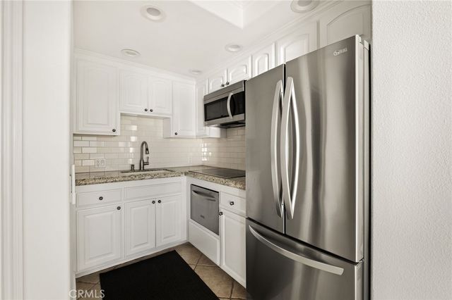 a kitchen with stainless steel appliances a refrigerator stove and sink