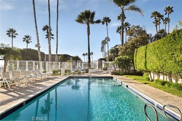 a view of swimming pool with chairs