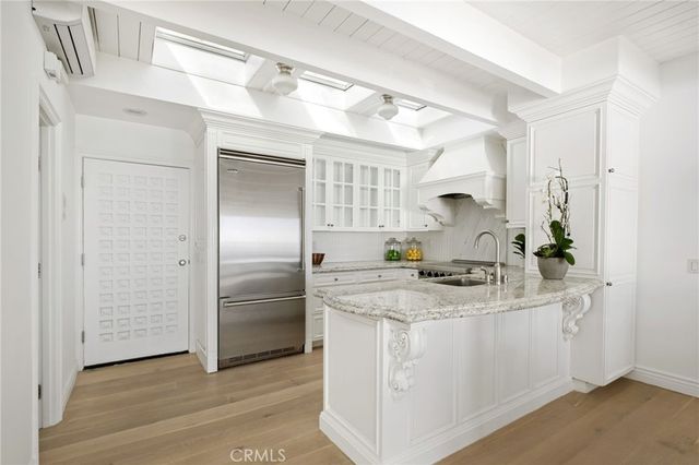 a kitchen with a sink appliances and cabinets