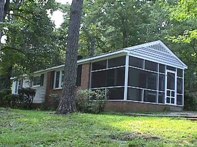 2201 Mossbank Road Raleigh, NC 27604 - Photo 1 of 1 a house with a big yard and large trees
