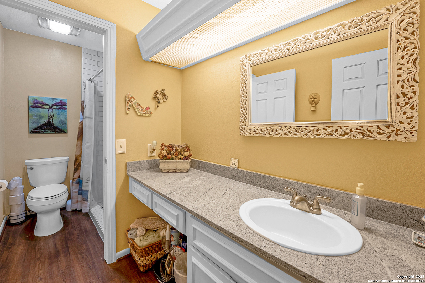 165 West Rampart Drive, Unit 706 San Antonio, TX 78216 - Photo 14 of 20 a bathroom with a granite countertop sink a toilet and a mirror