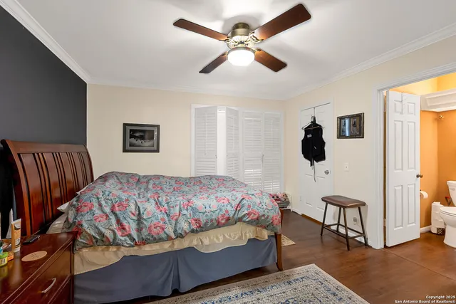 a bedroom with a bed and a table with a bookshelf