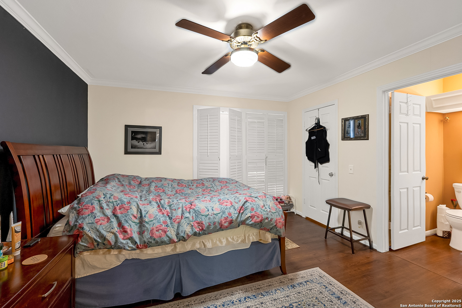 165 West Rampart Drive, Unit 706 San Antonio, TX 78216 - Photo 17 of 20 a bedroom with a bed and a table with a bookshelf