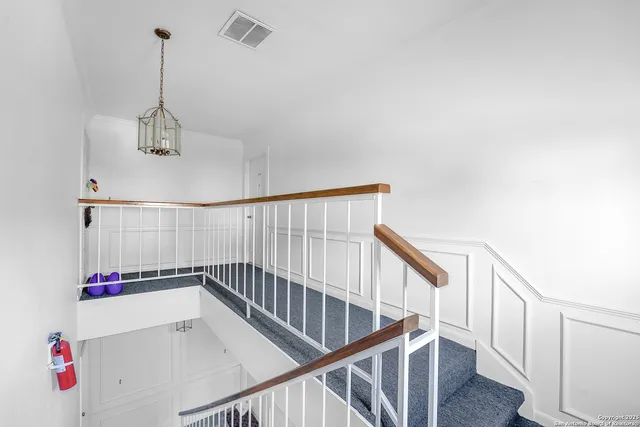 a view of room with stairs and wooden floor