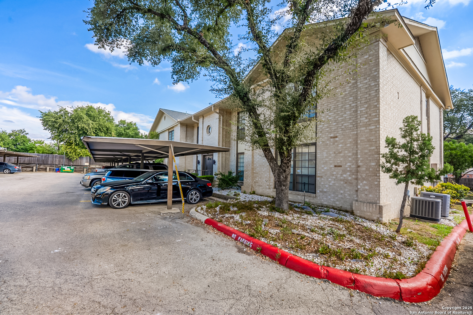 165 West Rampart Drive, Unit 706 San Antonio, TX 78216 - Photo 2 of 20 a view of backyard with large trees and a barn