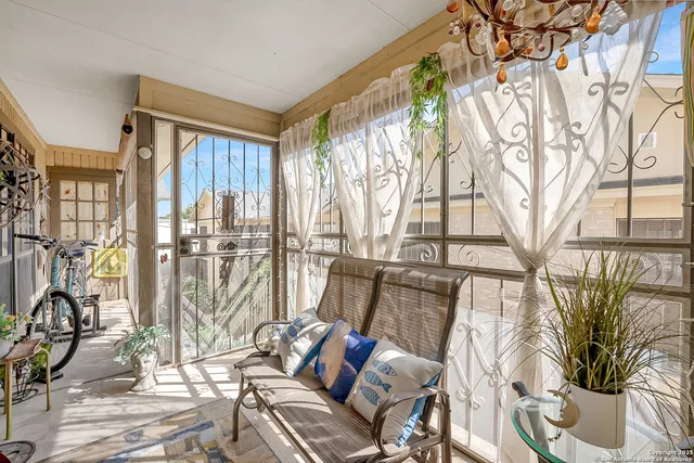 a living room with furniture and a floor to ceiling window