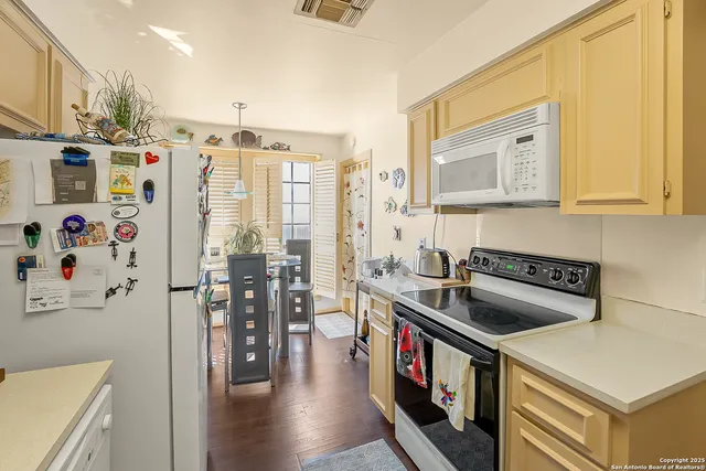 a kitchen with stainless steel appliances granite countertop a stove and a refrigerator