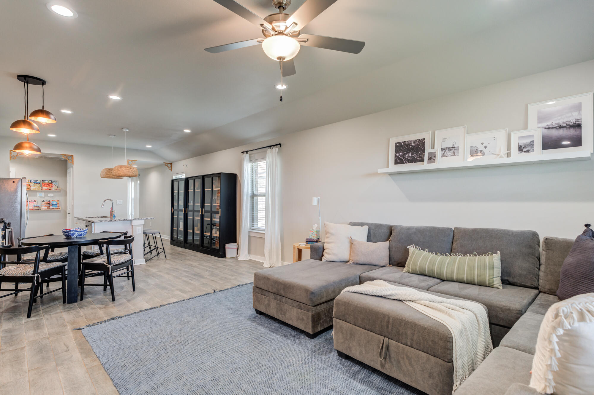 4613 126th Street Lubbock, TX 79424 - Photo 5 of 37 a living room with furniture and a dining table with wooden floor