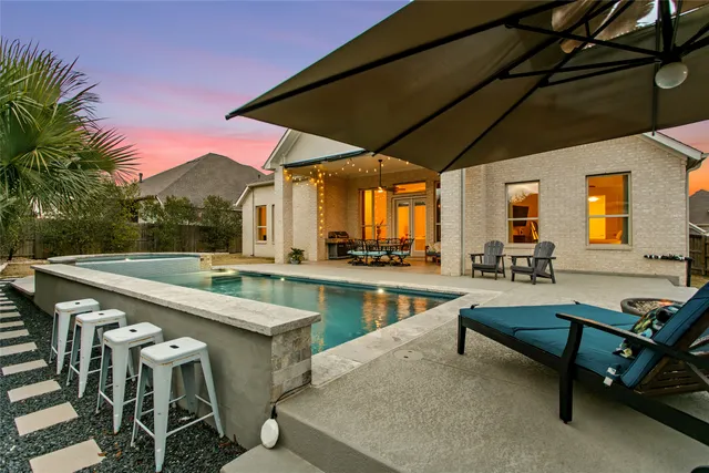 swimming pool view with a seating space