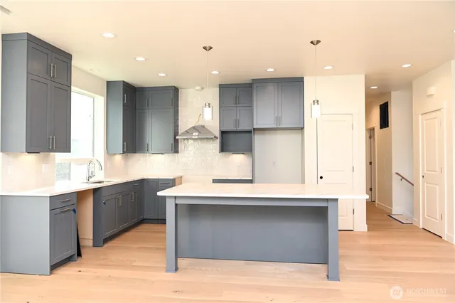 a large kitchen with stainless steel appliances kitchen island granite countertop a large counter top and sink