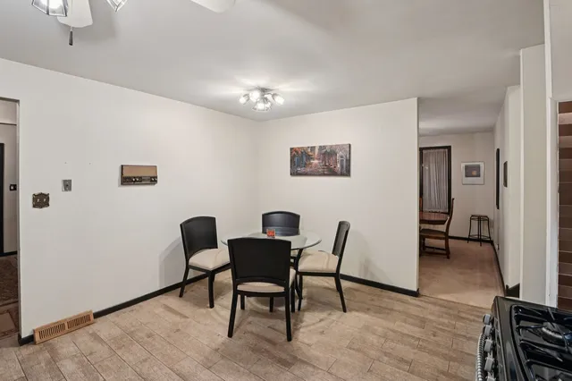 a view of a room with furniture and wooden floor