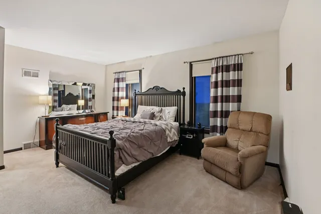 a bedroom with a bed couch and a window