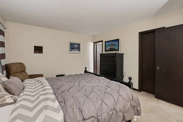 a bedroom with a bed and a tv