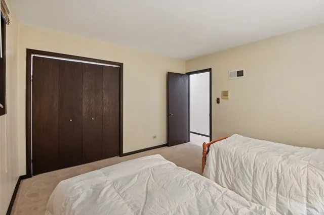 a bedroom with a bed and a mirror