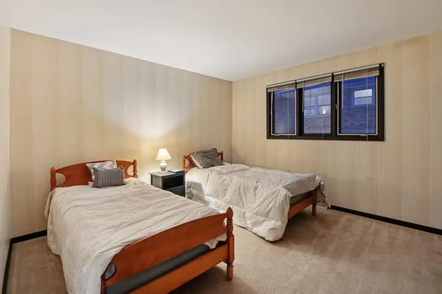 a bedroom with two beds and painted walls