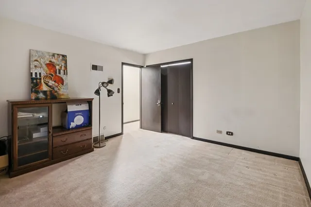 a view of an empty room with painting on the wall