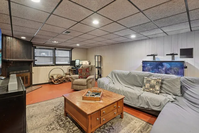 a living room with furniture a flat screen tv and a table