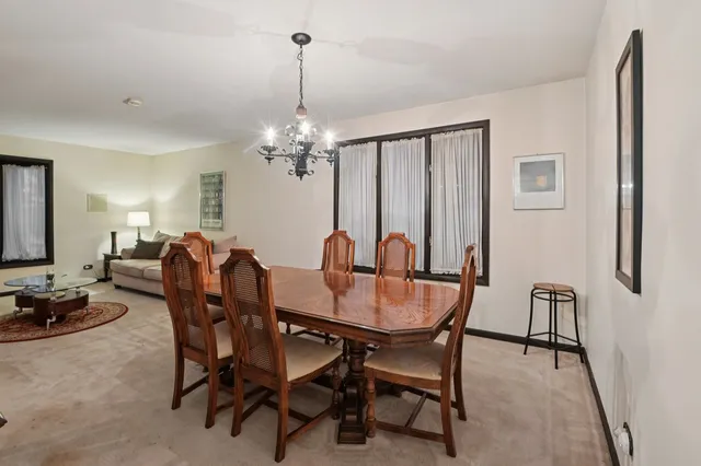 a view of a dining room with furniture and chandelier