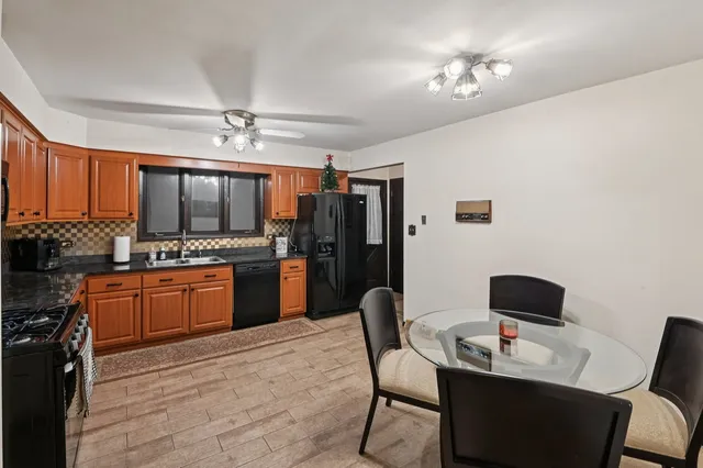 a kitchen with a refrigerator and a stove