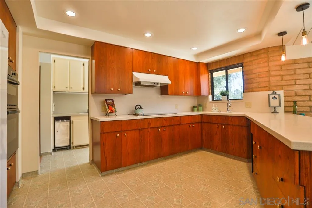 1211 Palomino Road Fallbrook, CA 92028 - Photo 14 of 25 a kitchen with stainless steel appliances granite countertop a sink a stove and cabinets