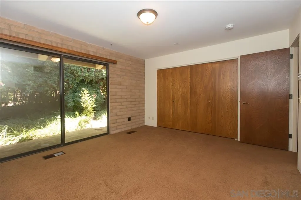 1211 Palomino Road Fallbrook, CA 92028 - Photo 15 of 25 a view of an empty room with a sliding door