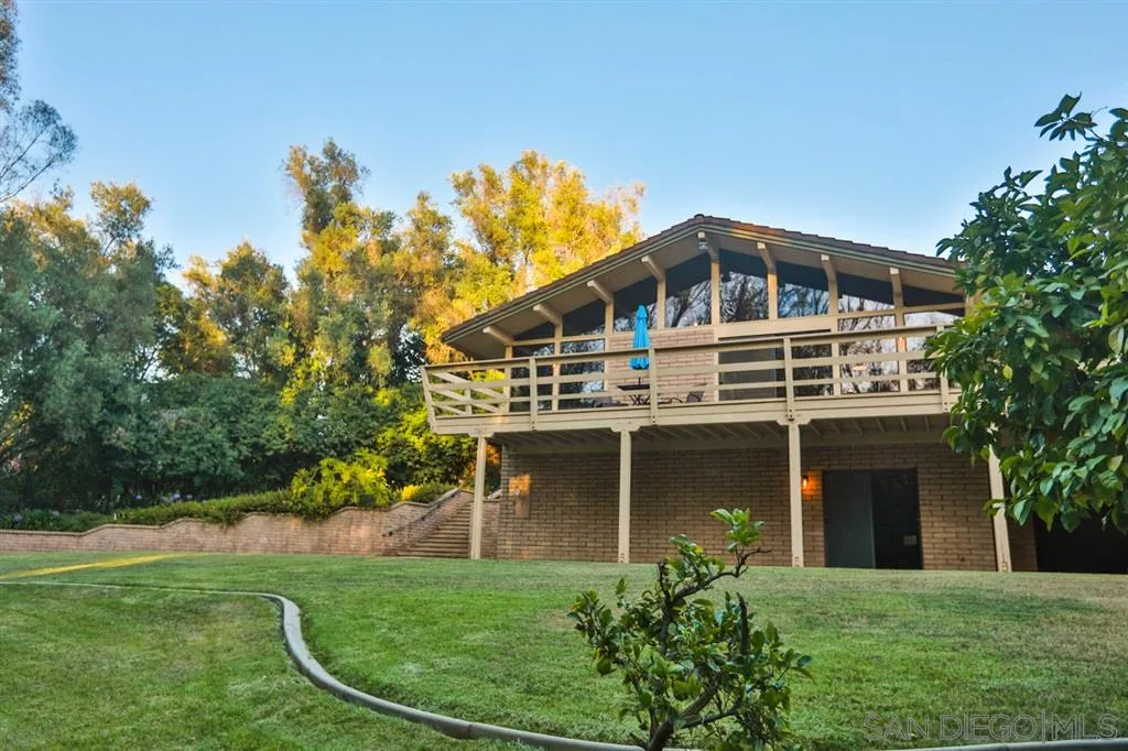 1211 Palomino Road Fallbrook, CA 92028 - Photo 21 of 25 a front view of a house with a garden