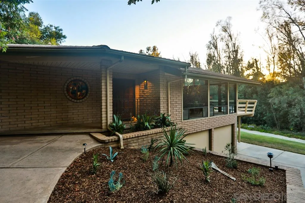 1211 Palomino Road Fallbrook, CA 92028 - Photo 3 of 25 a view of house with backyard and outdoor seating