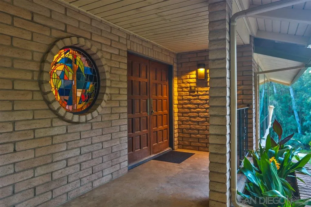 1211 Palomino Road Fallbrook, CA 92028 - Photo 4 of 25 a view of a door with brick walls