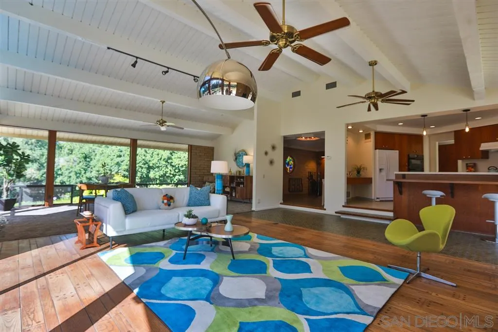 1211 Palomino Road Fallbrook, CA 92028 - Photo 7 of 25 a living room with lots of furniture and a rug