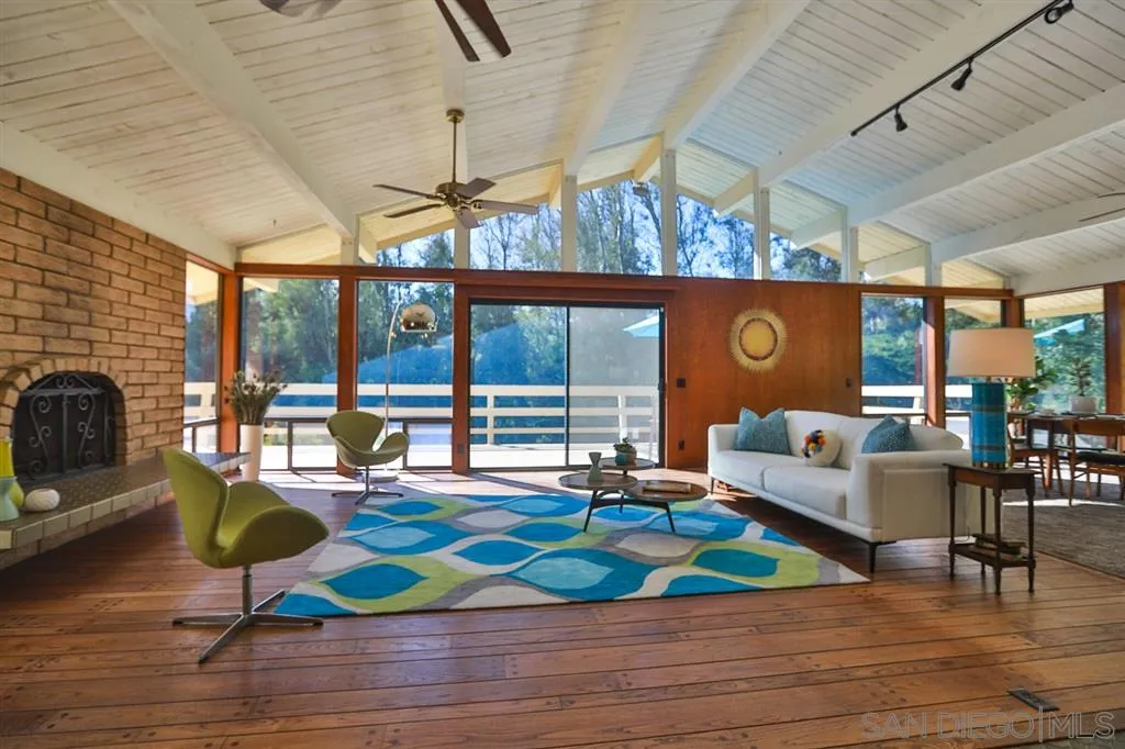 1211 Palomino Road Fallbrook, CA 92028 - Photo 9 of 25 a living room with patio furniture and a fireplace