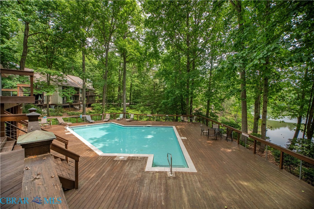 54 Villa Ridge Drive, Unit C Hartfield, VA 23071 - Photo 29 of 45 Community pool with a deck and view of scattered trees