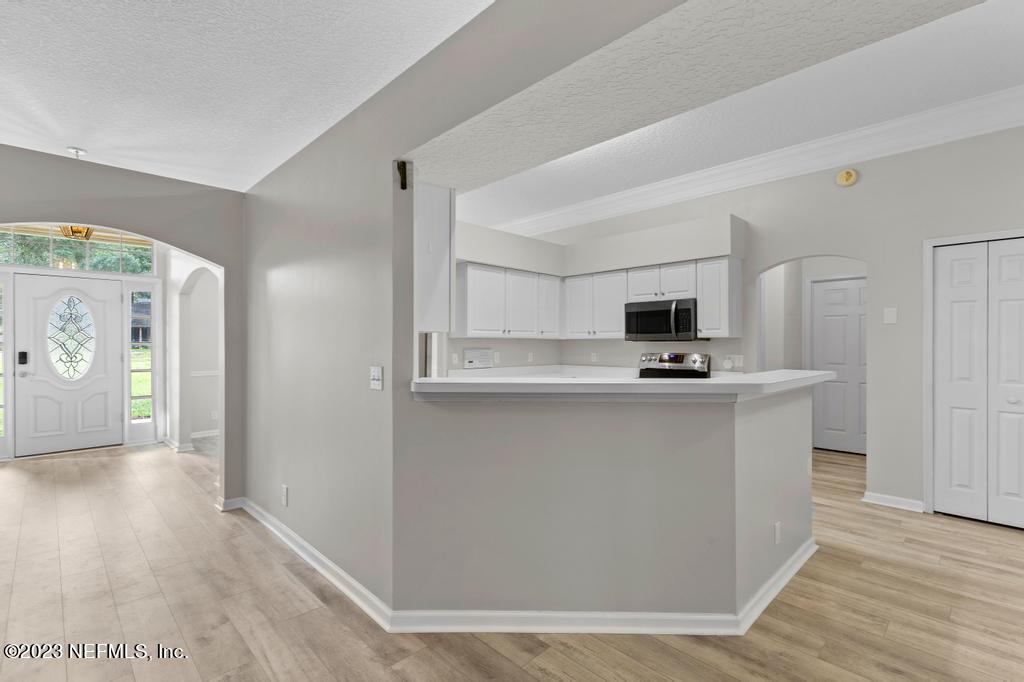 691 Nottingham Forest Circle St. Johns, FL 32259 - Photo 11 of 44 a view of kitchen with stainless steel appliances refrigerator stove microwave and cabinets