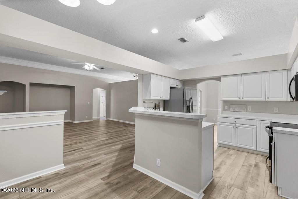 691 Nottingham Forest Circle St. Johns, FL 32259 - Photo 12 of 44 a kitchen with white cabinets and sink