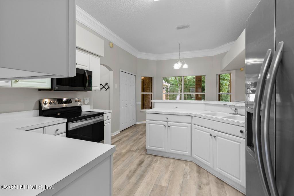 691 Nottingham Forest Circle St. Johns, FL 32259 - Photo 17 of 44 a kitchen with granite countertop a refrigerator stove top oven and sink