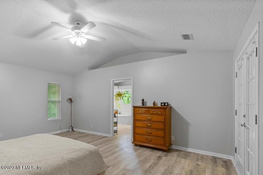 691 Nottingham Forest Circle St. Johns, FL 32259 - Photo 18 of 44 a bedroom with a bed and a chandelier