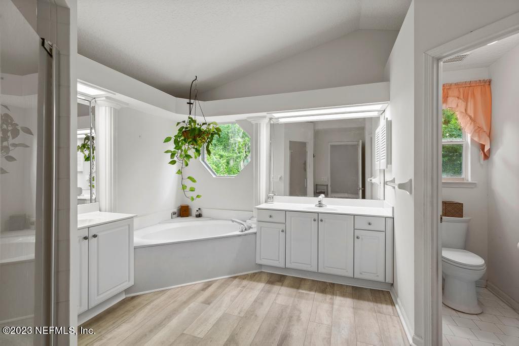 691 Nottingham Forest Circle St. Johns, FL 32259 - Photo 21 of 44 a bathroom with a sink mirror and a bathtub