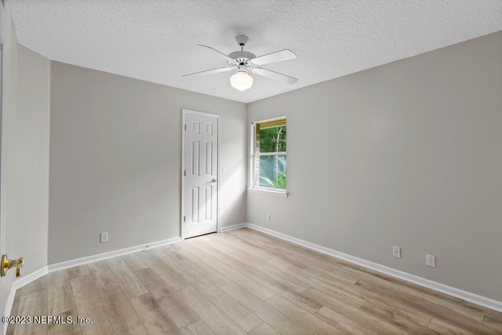 691 Nottingham Forest Circle St. Johns, FL 32259 - Photo 25 of 44 wooden floor in an empty room with a window