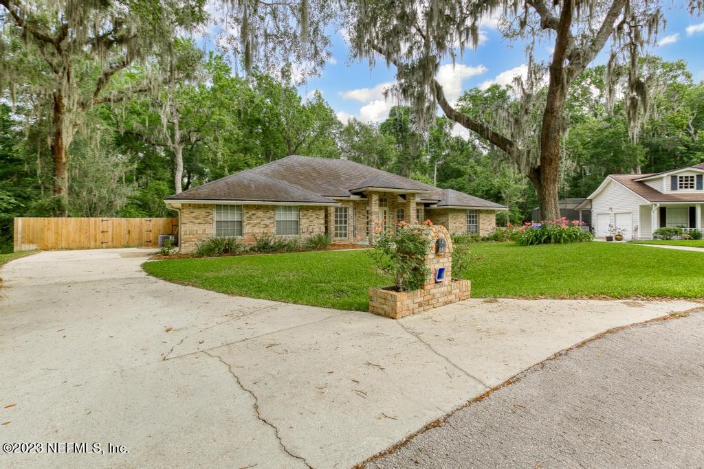 691 Nottingham Forest Circle St. Johns, FL 32259 - Photo 43 of 44 a house with green field in front of it