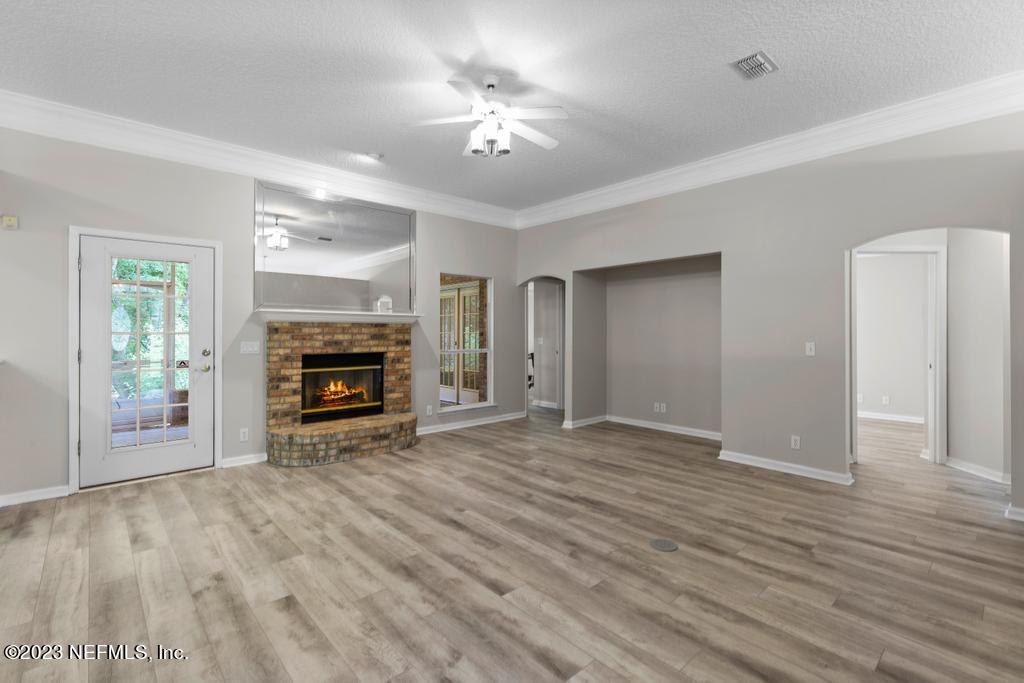 691 Nottingham Forest Circle St. Johns, FL 32259 - Photo 9 of 44 a view of empty room with fireplace and wooden floor