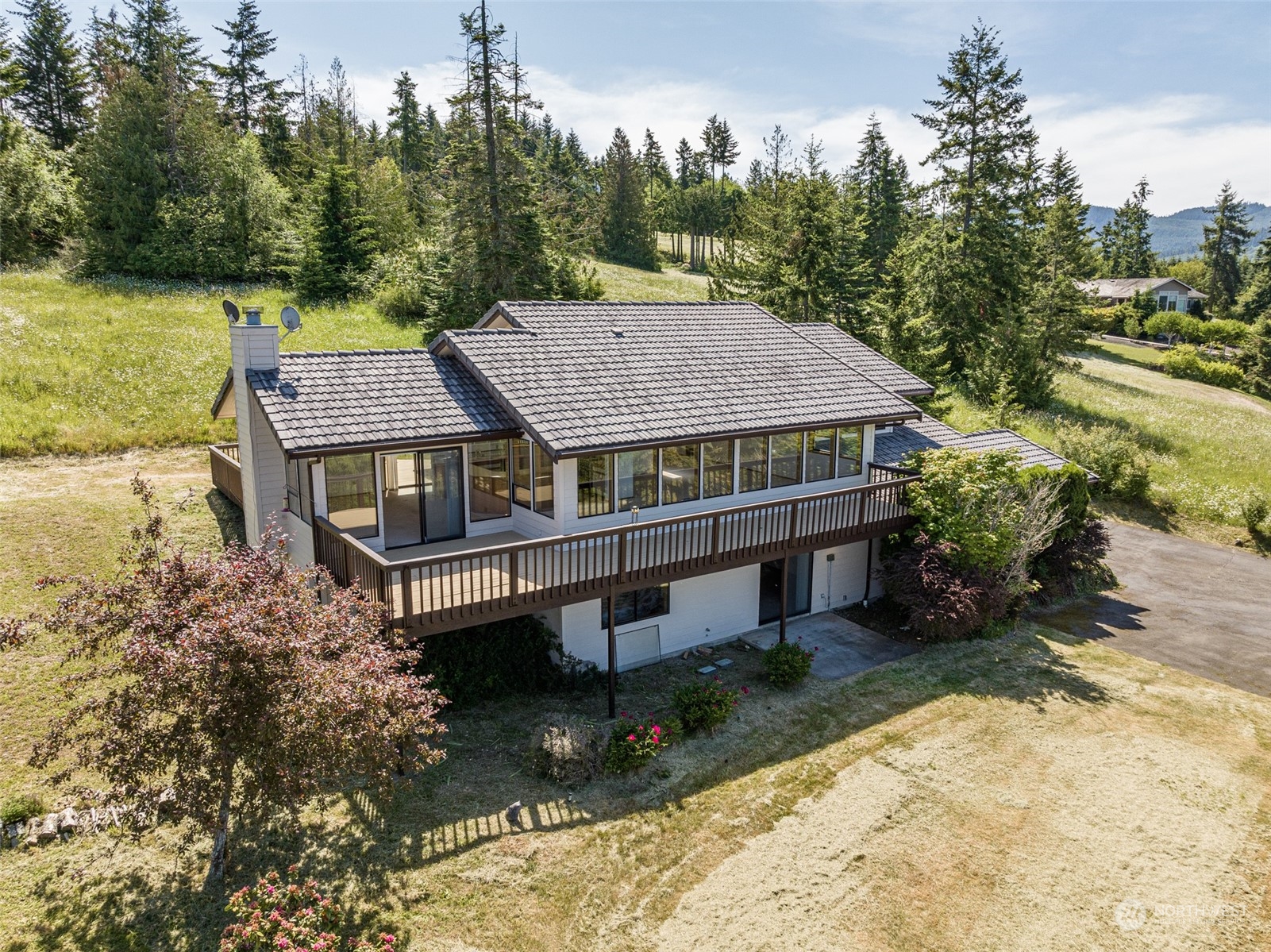 773 Ravens Ridge Road Sequim, WA 98382 - Photo 1 of 38 an aerial view of a house with a yard table and chairs
