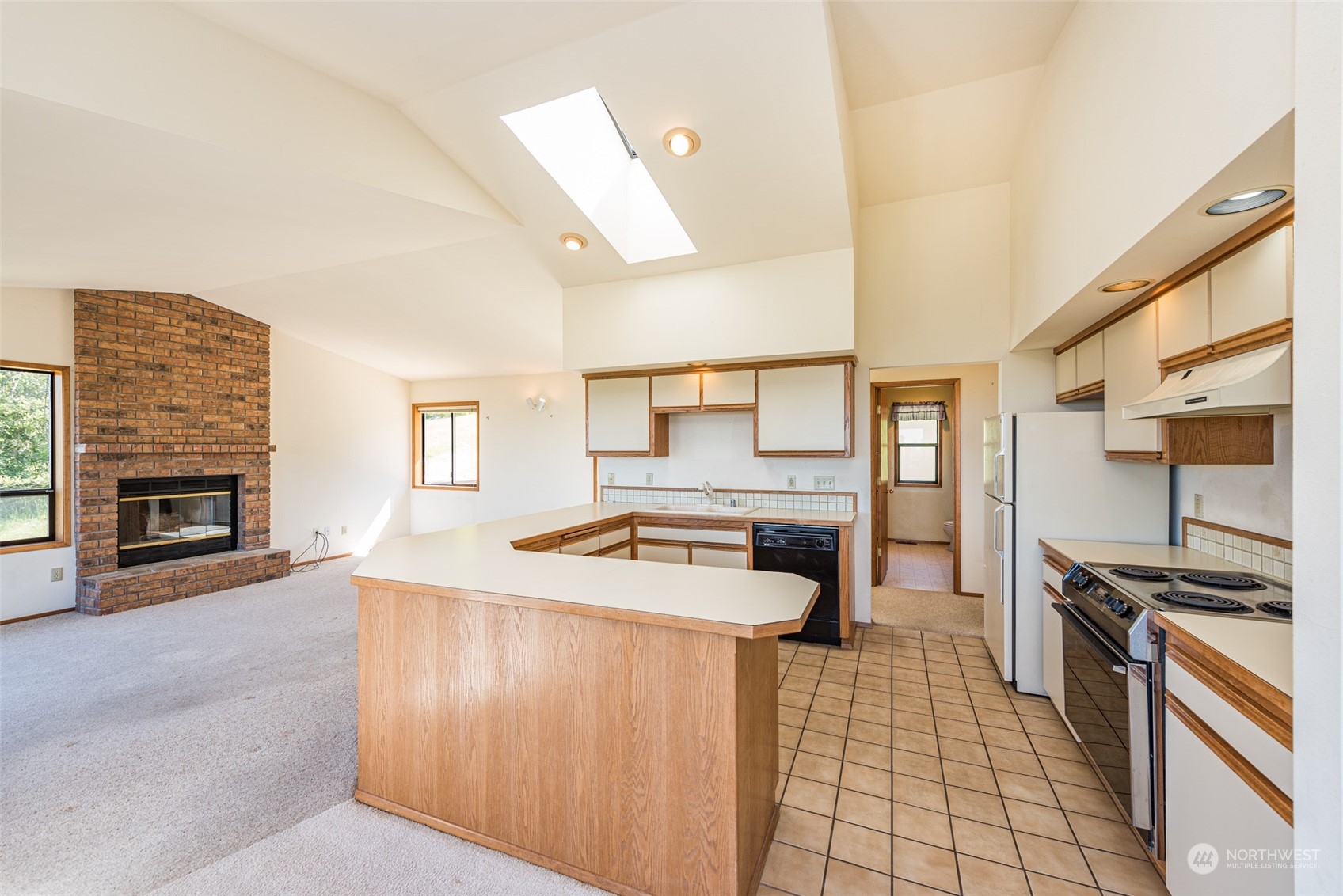 773 Ravens Ridge Road Sequim, WA 98382 - Photo 15 of 38 a kitchen with granite countertop a stove and a refrigerator