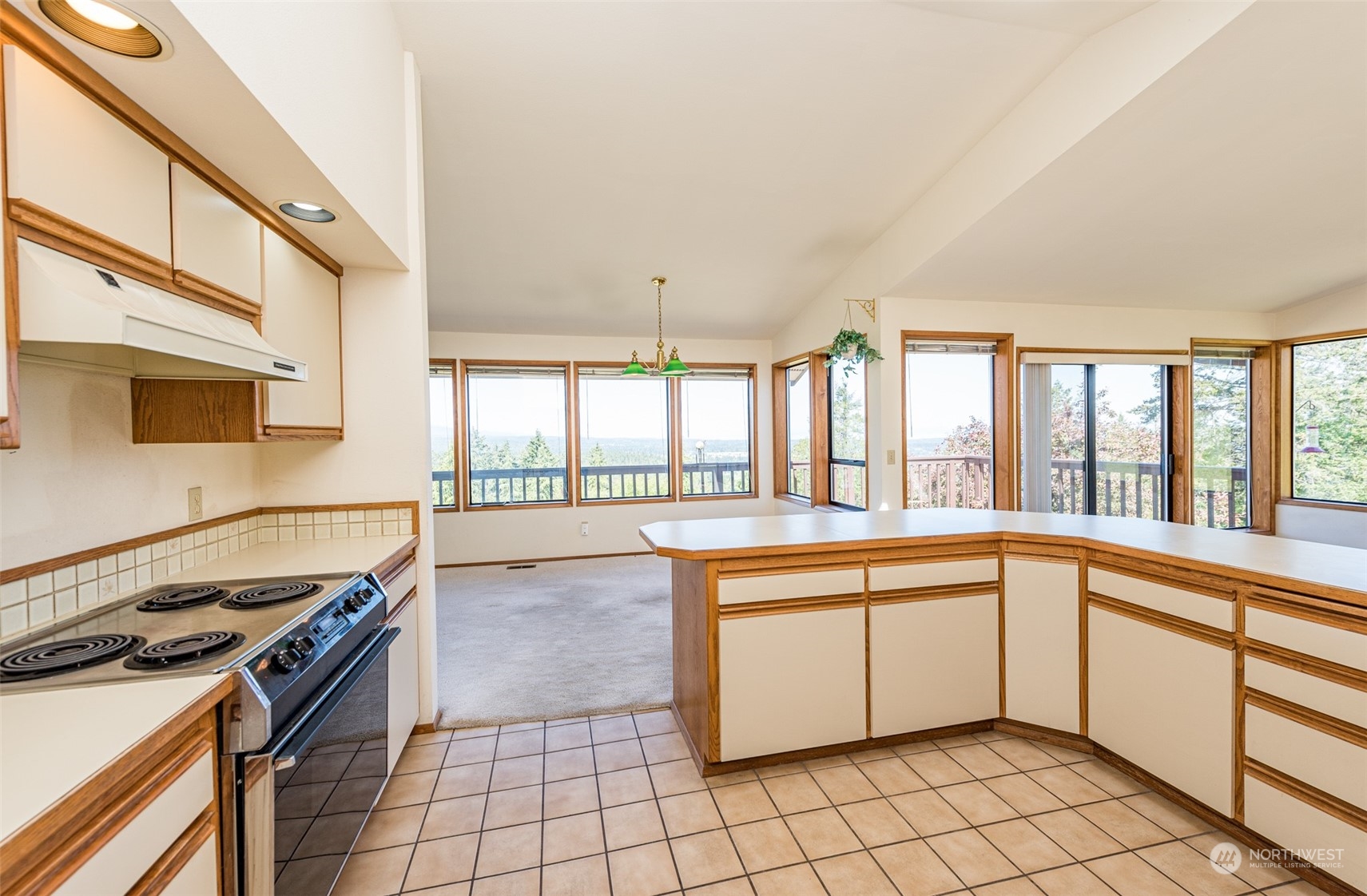 773 Ravens Ridge Road Sequim, WA 98382 - Photo 16 of 38 a kitchen with a stove a sink and a refrigerator