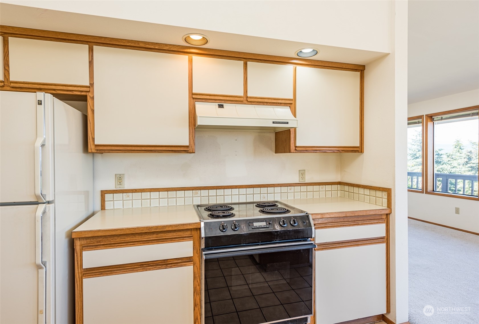 773 Ravens Ridge Road Sequim, WA 98382 - Photo 17 of 38 a kitchen with a stove and a microwave